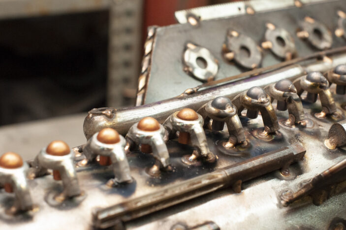 copper rivets being welded to the ladder