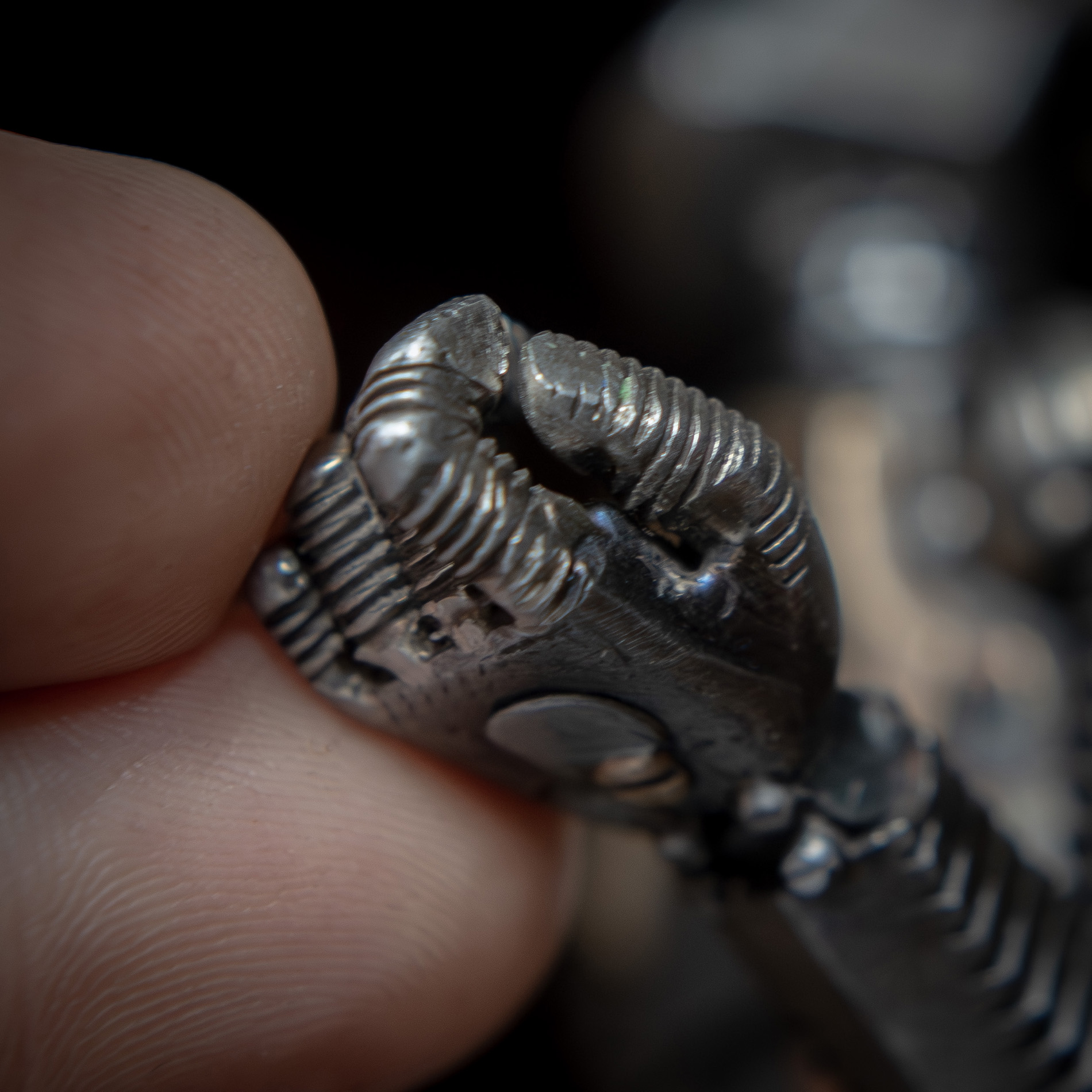 An artist's fingers show the scale of this tiny robot hand - less than the size of a fingernail