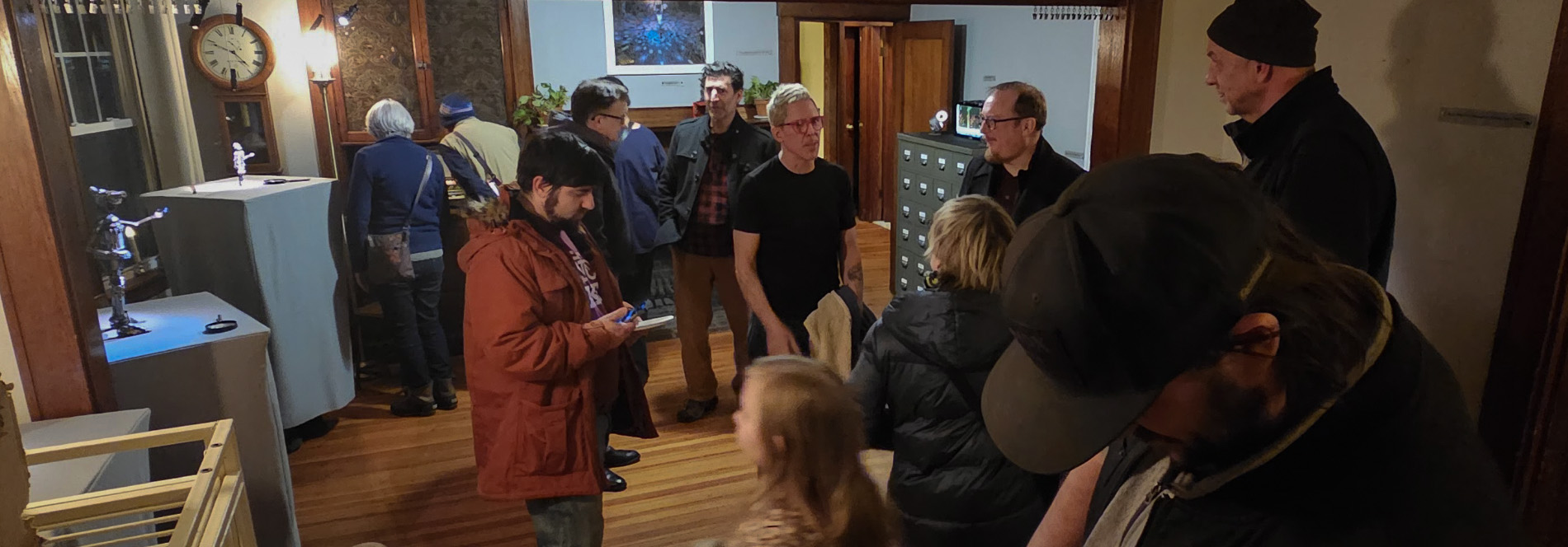 people gathered in a home converted to an art gallery